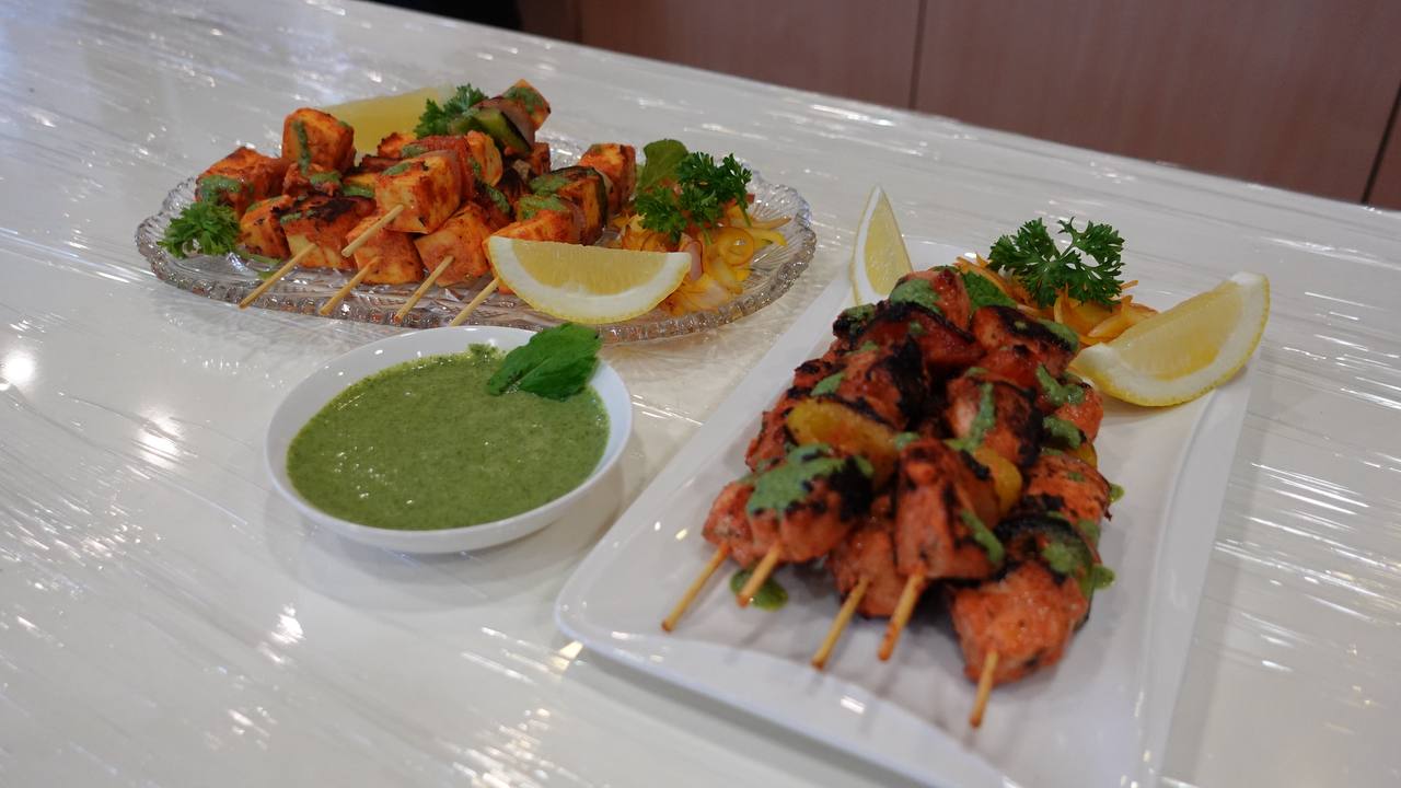 Chef Sapna demonstrating a step in the tikka preparation.