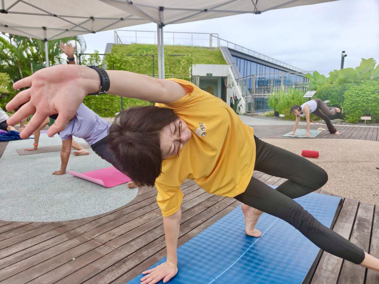 Participants performing yoga poses in a serene garden setting