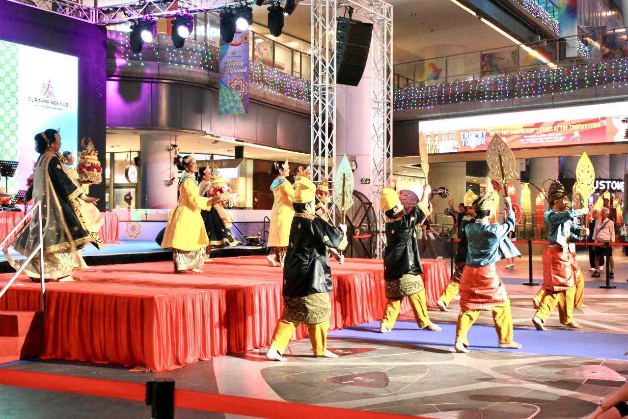 A panoramic view of the illuminated Festive Plaza bustling with activity during Malam Tari Irama Melayu