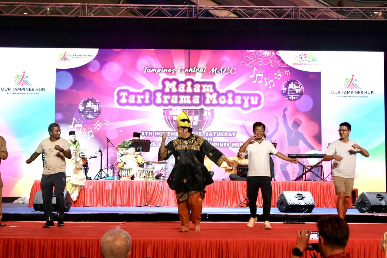 A group of musicians playing traditional Malay instruments with enthusiasm during the cultural event