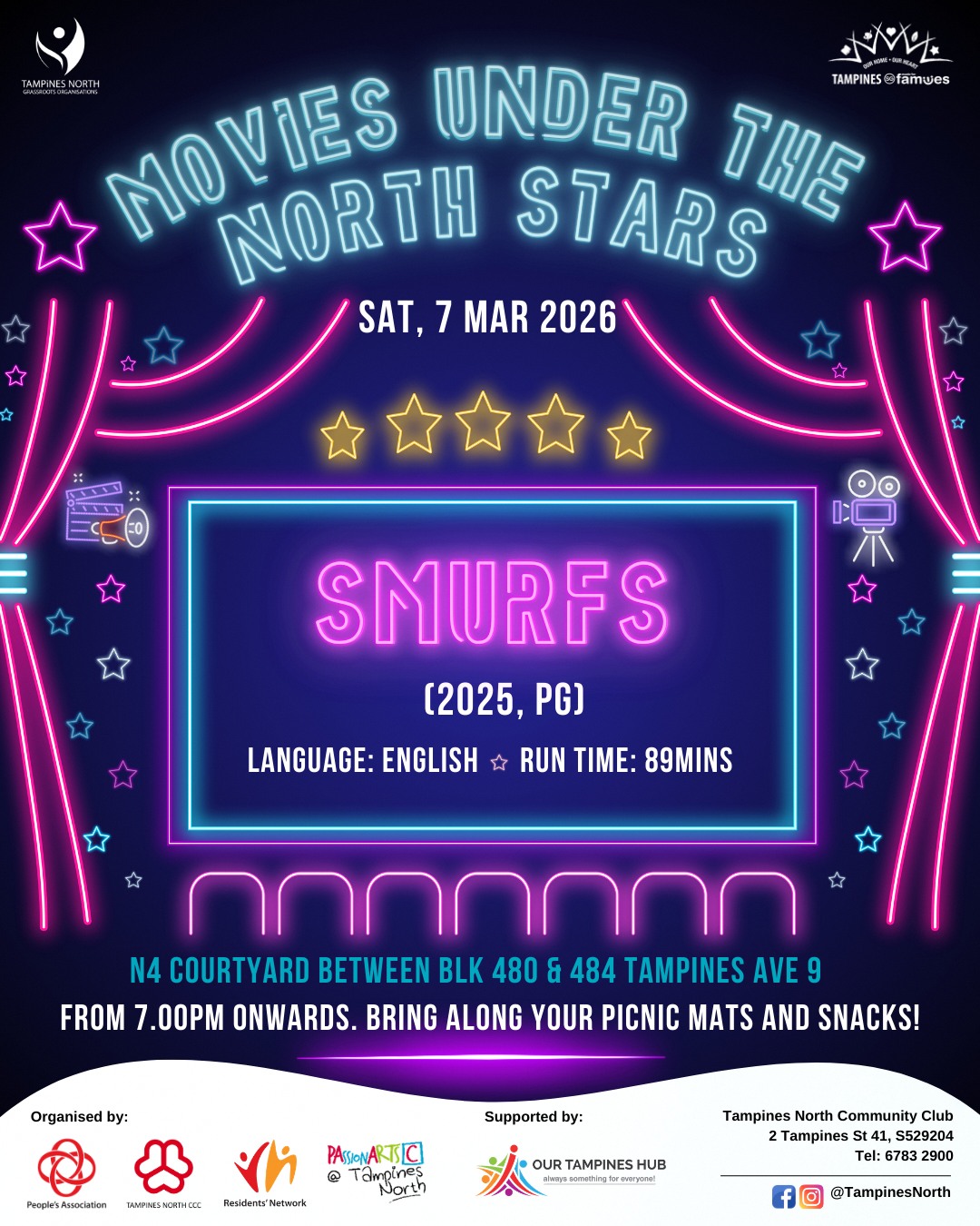 Community members gathering for an outdoor movie screening at night