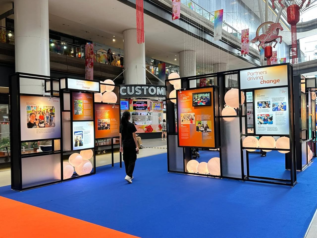 Exhibition panels showcasing social service stories