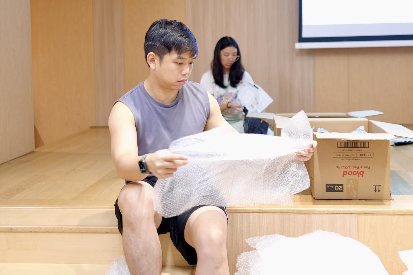 Participants meticulously sorting clean packaging materials.