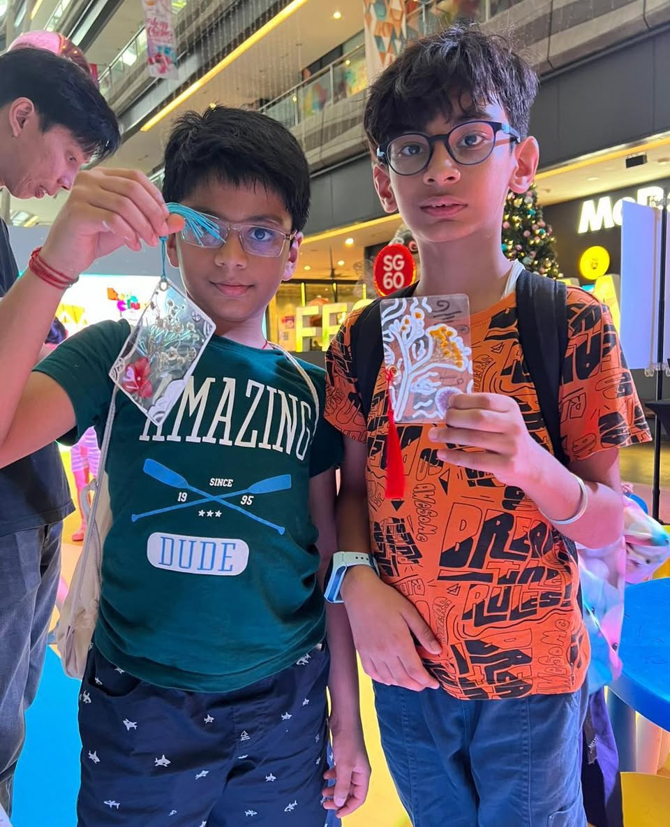 A child holding a pressed flower bookmark