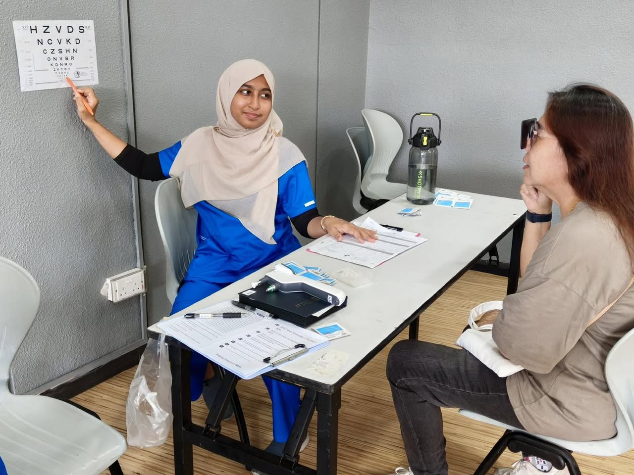 Community members participating in eye health activities at Our Tampines Hub