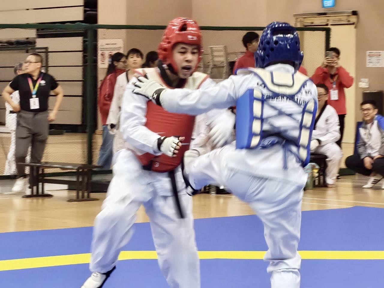 Intense kyorugi bout in progress at Our Tampines Hub