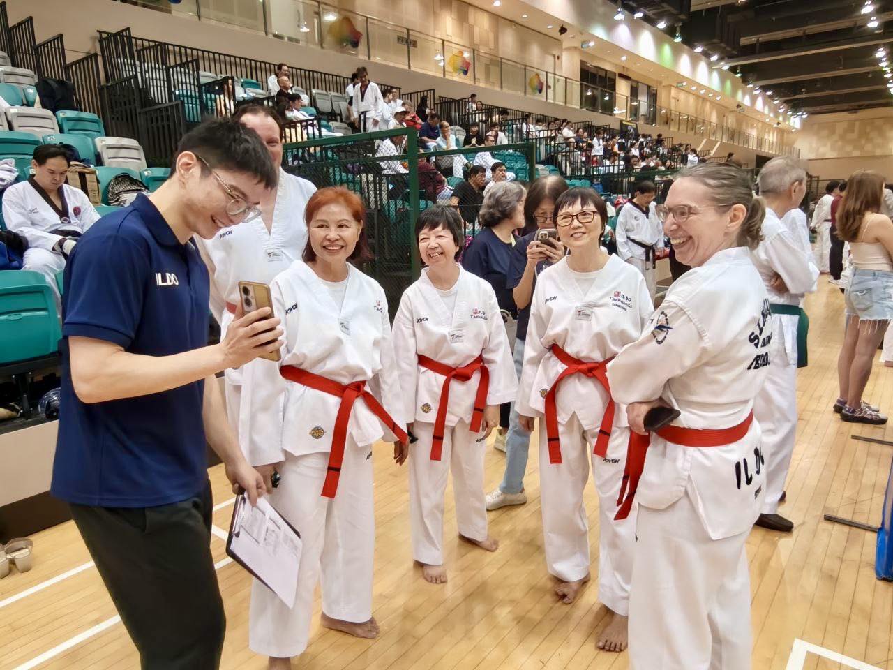A group photo of participants and officials at the Taekwondo event