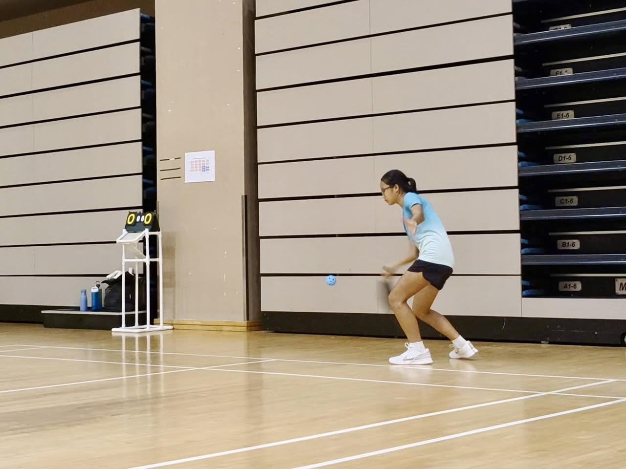 A dynamic action shot of players competing at the Singapore Pickleball Novice 2026.