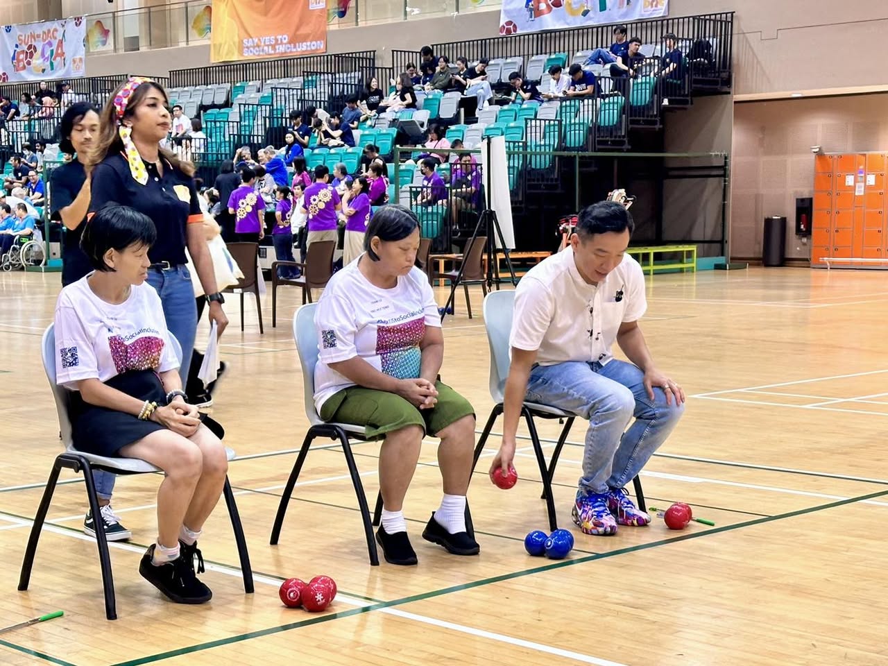 A volunteer assisting an athlete at an experiential station during the event