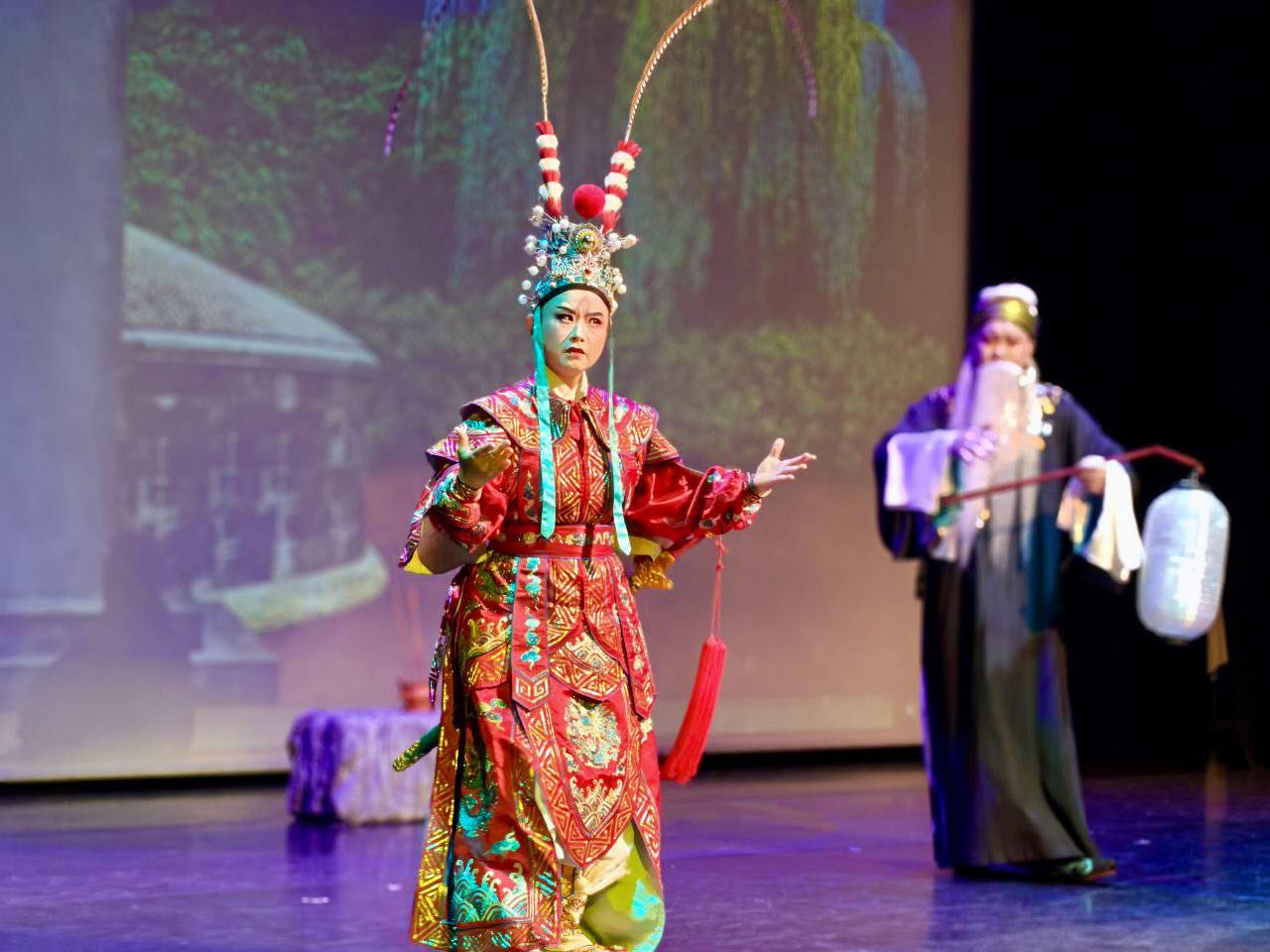 Close-up of a Teochew opera performer with intricate facial makeup and elaborate headwear.