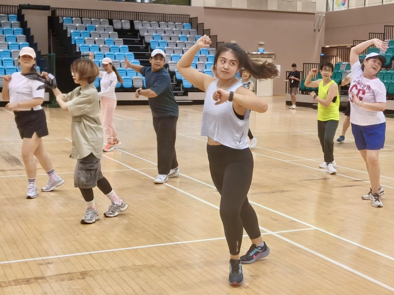 Chris Park leading a vibrant Zumba class with many participants.