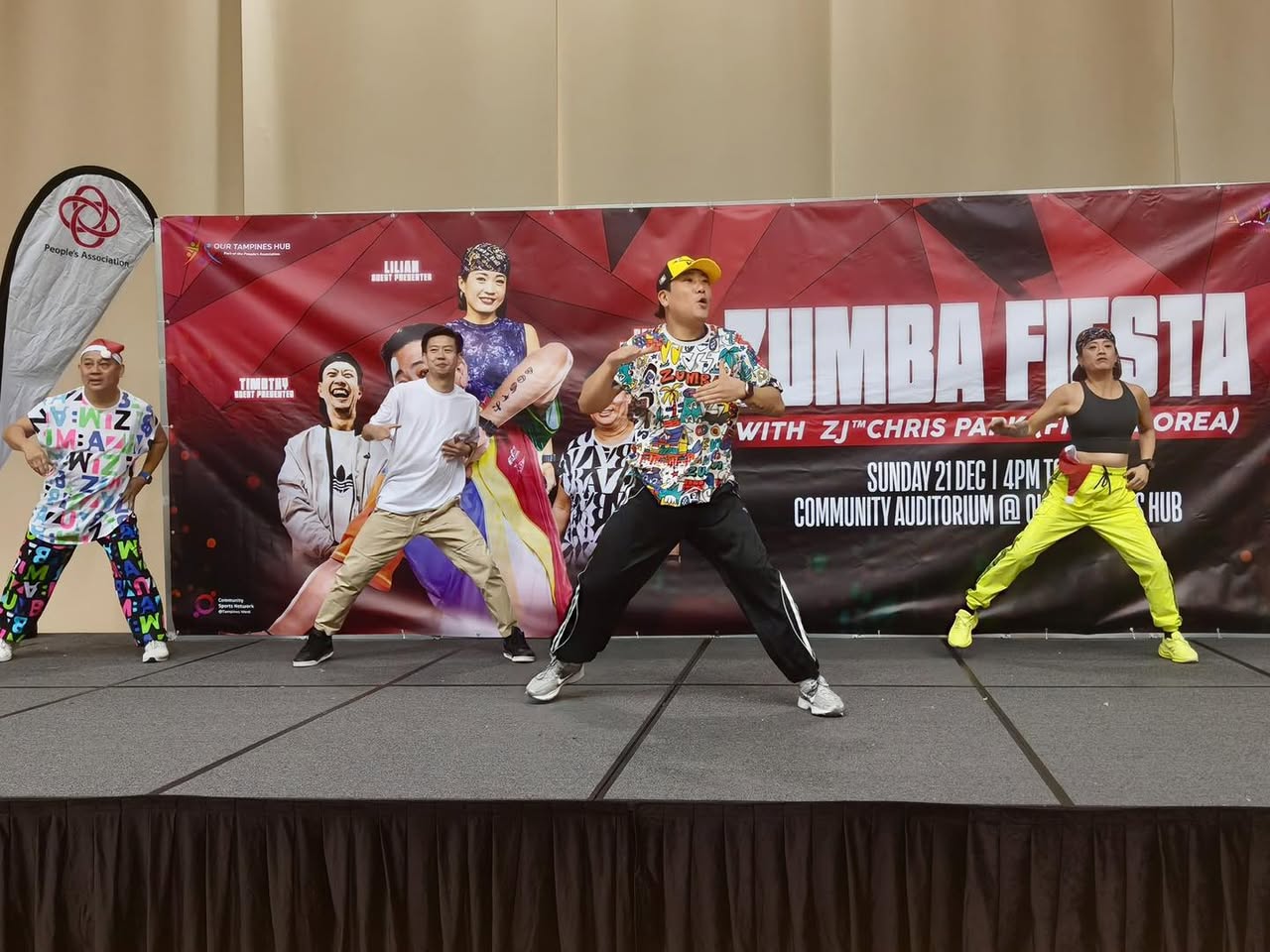 A large crowd actively participating in a Zumba workout.