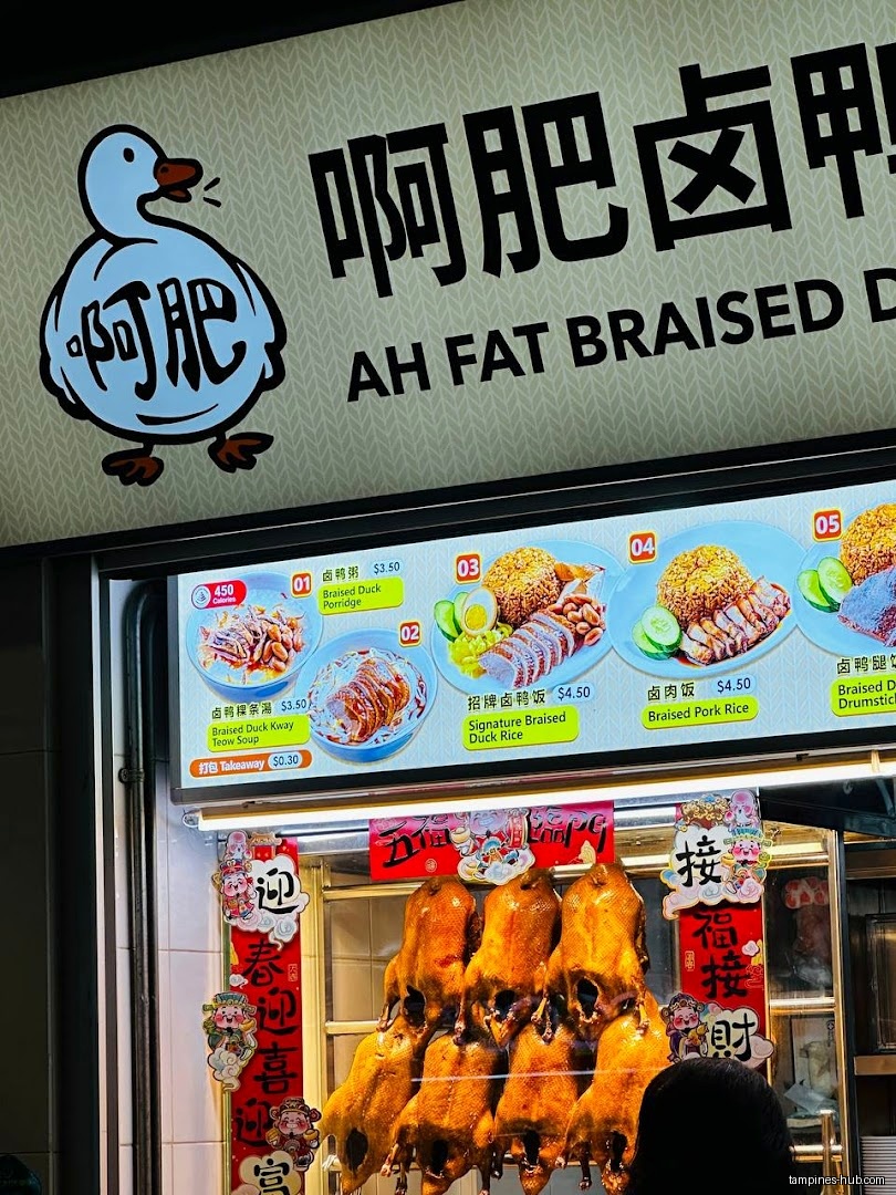 Ah Fat Braised Duck Rice shop front with menu and hanging ducks.