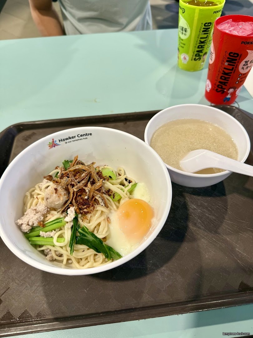 A tray with a bowl of noodles, soup, and two drinks.
