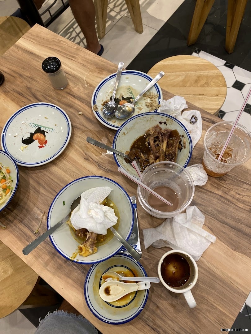 The image shows a table with empty bowls and cups after a meal.