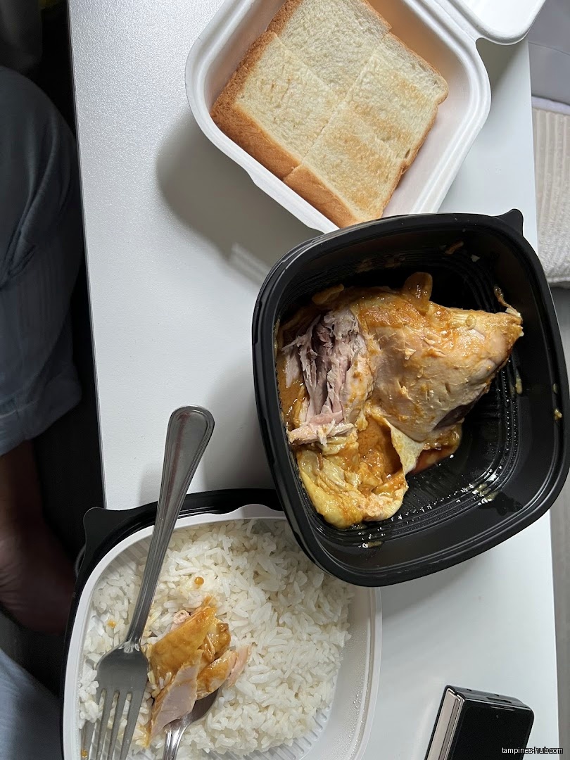 Overhead shot of a meal with rice, chicken, and toast in containers.