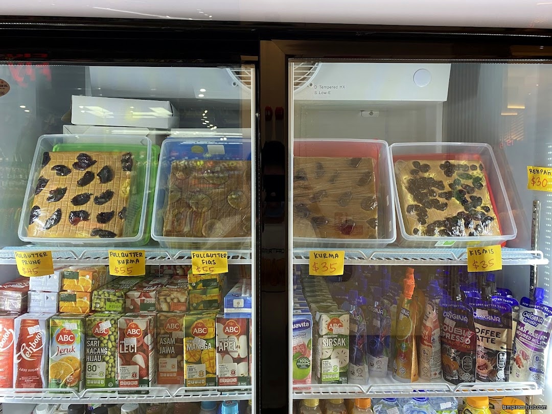 A refrigerator displays cakes, juices, and drinks at Al Barakah Tampines Hub.