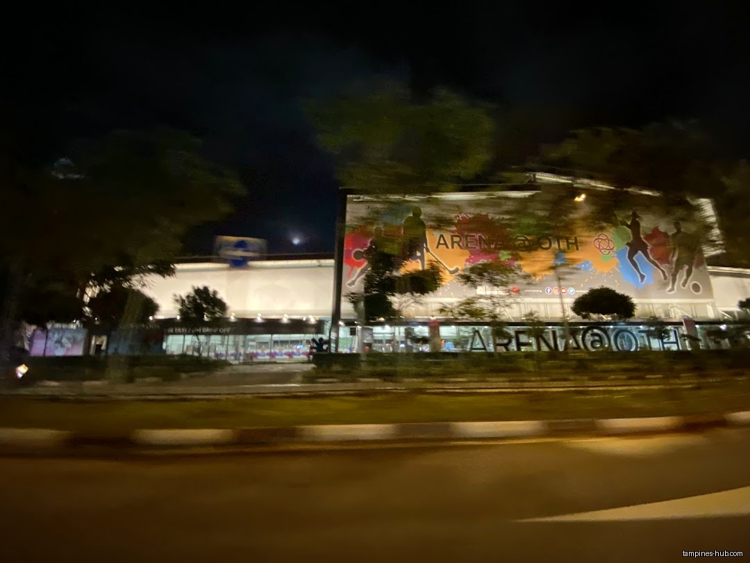 The image shows the exterior of the Arena @ OTH shop at night.
