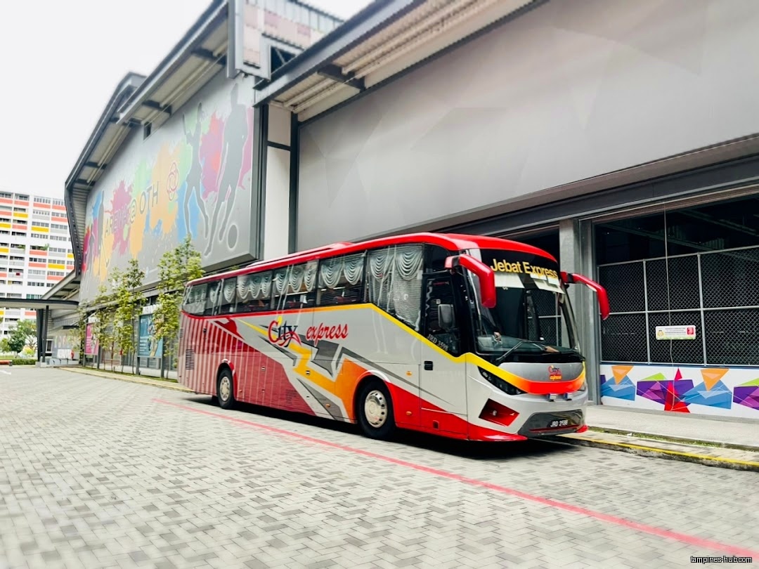 Arena @ OTH shop front with a parked Jebat Express bus.