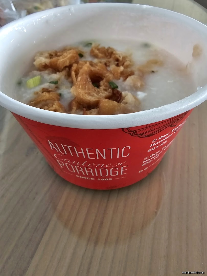 A bowl of Cantonese porridge topped with fried dough sticks.