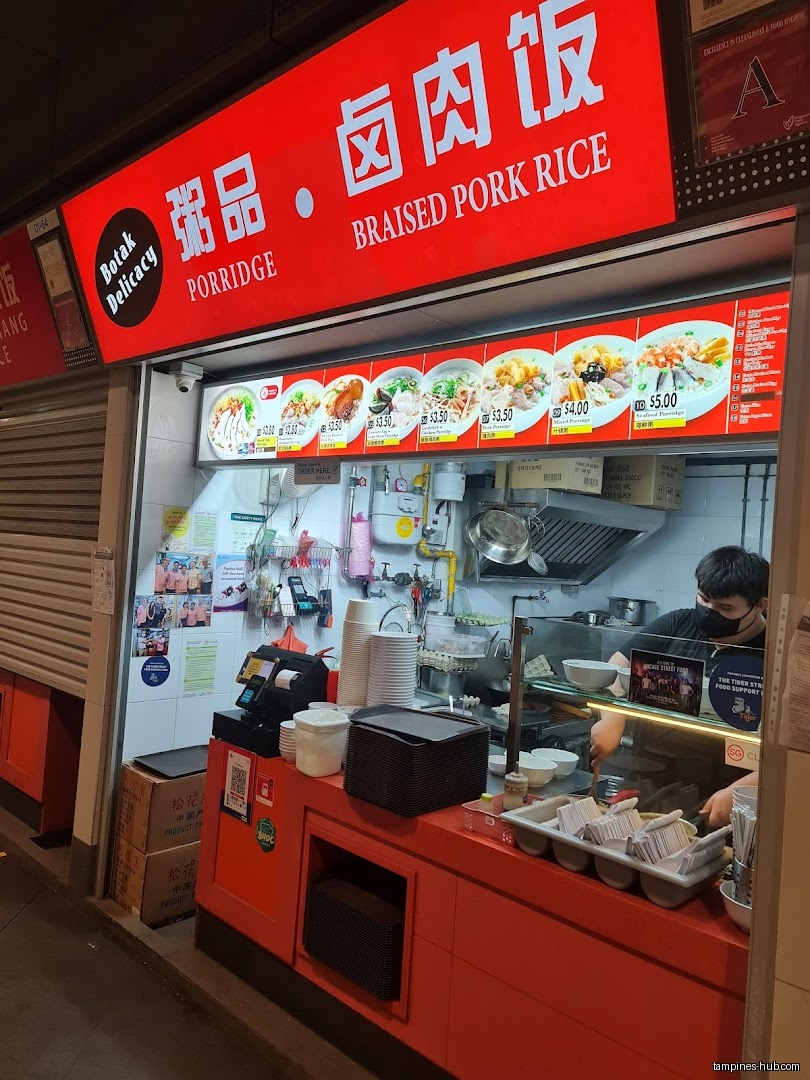 Botak Cantonese Porridge shop front with menu and staff visible.