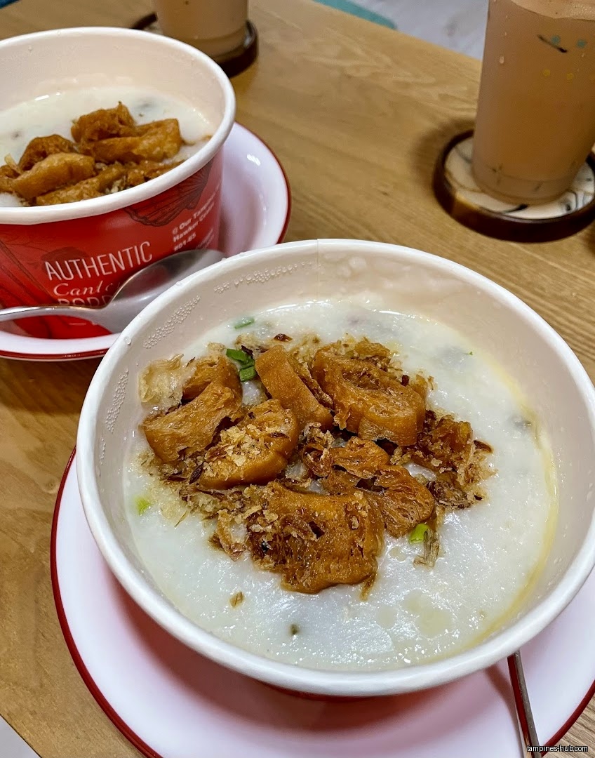 Two bowls of Botak Cantonese Porridge with fried dough and drinks.