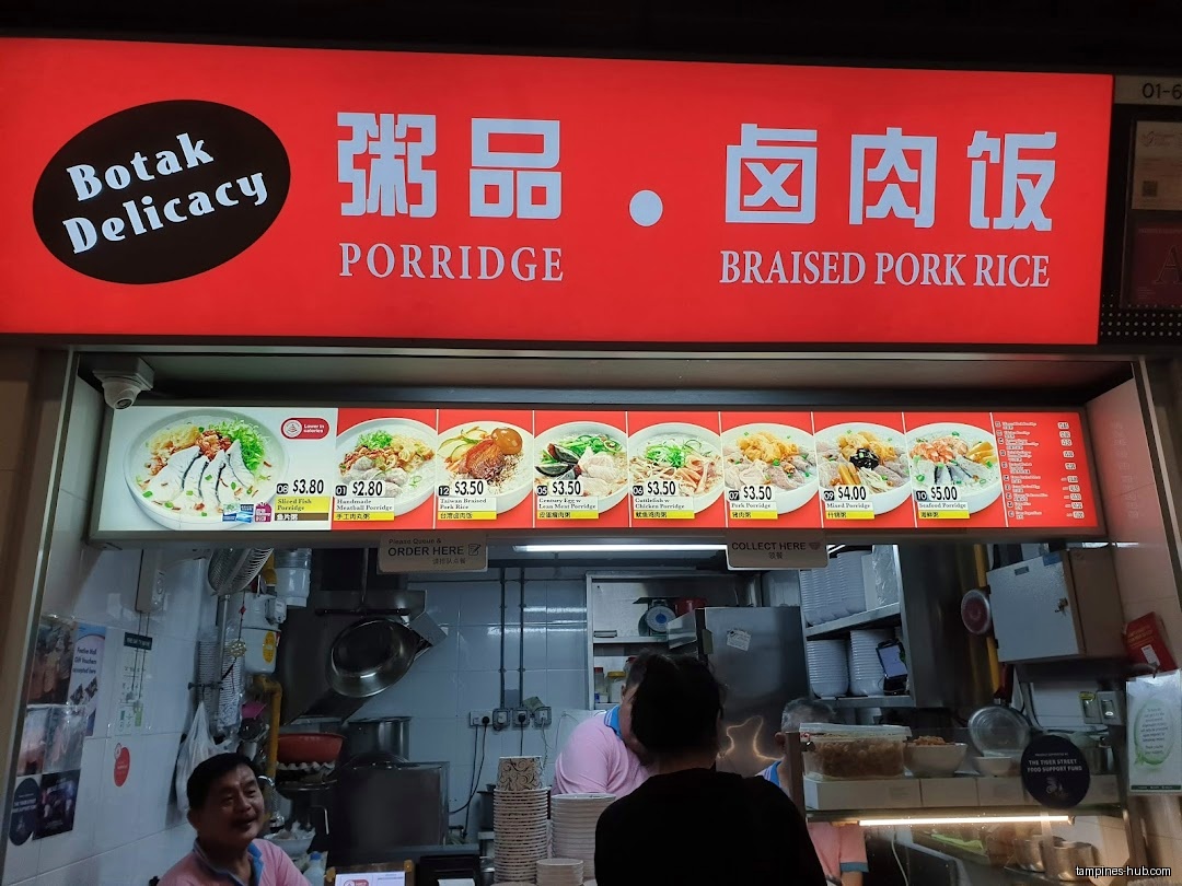 Botak Cantonese Porridge shop front with menu board and staff visible.