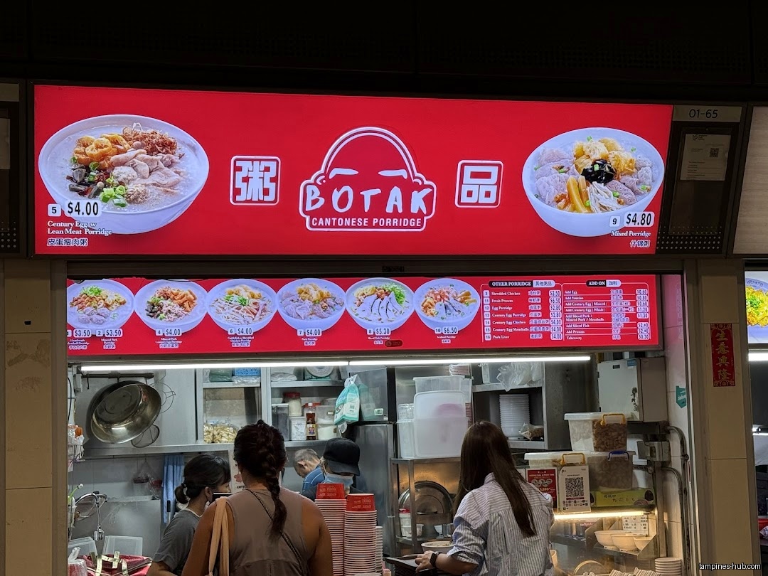 The image shows the menu board of Botak Cantonese Porridge with prices.