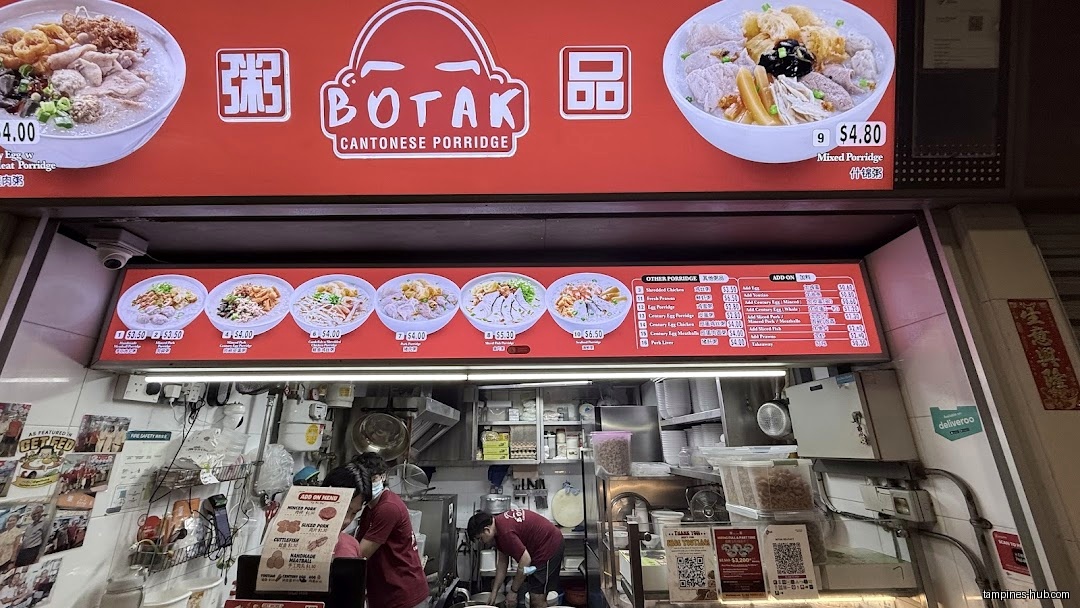 Botak Cantonese Porridge shop front with menu board and staff visible.