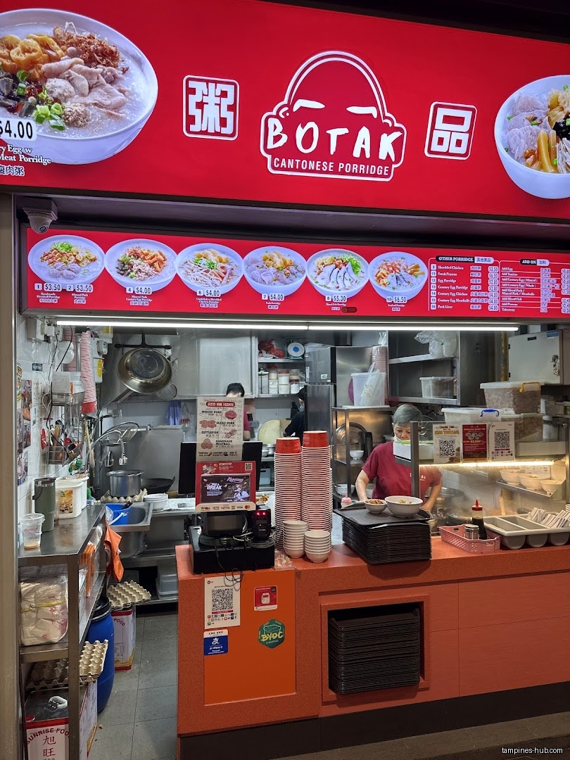 Botak Cantonese Porridge shop front with menu board and staff visible.