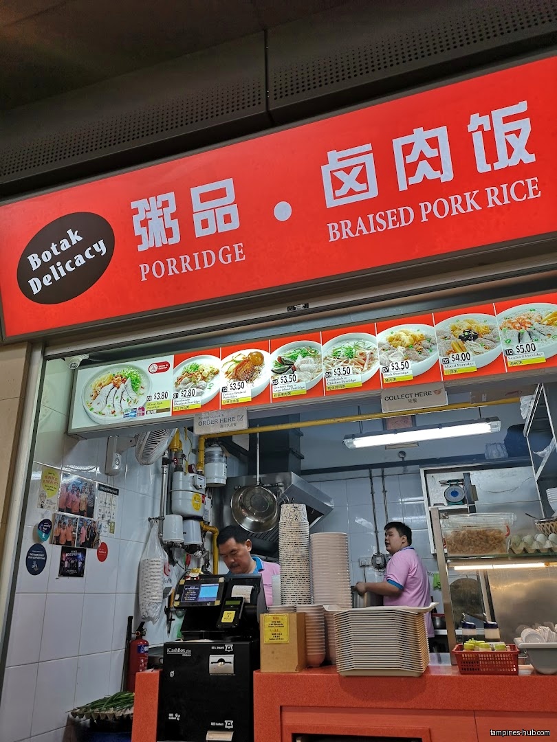 Botak Cantonese Porridge shop front with menu and staff visible.