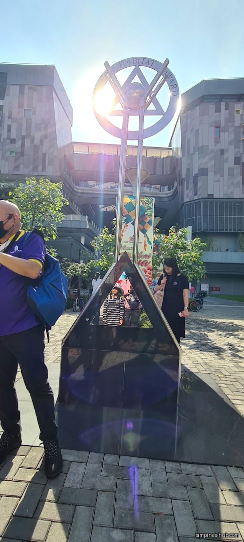The image shows a Habitat Award monument in front of Central Plaza.