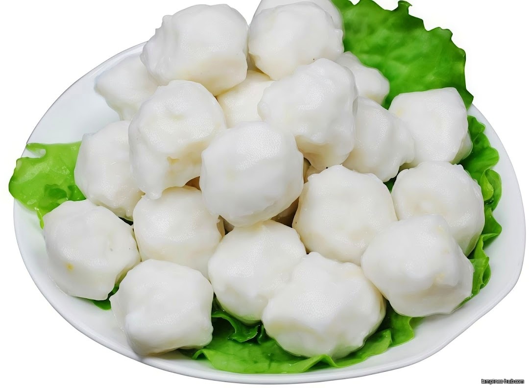 A plate of white fish balls with green lettuce garnish.
