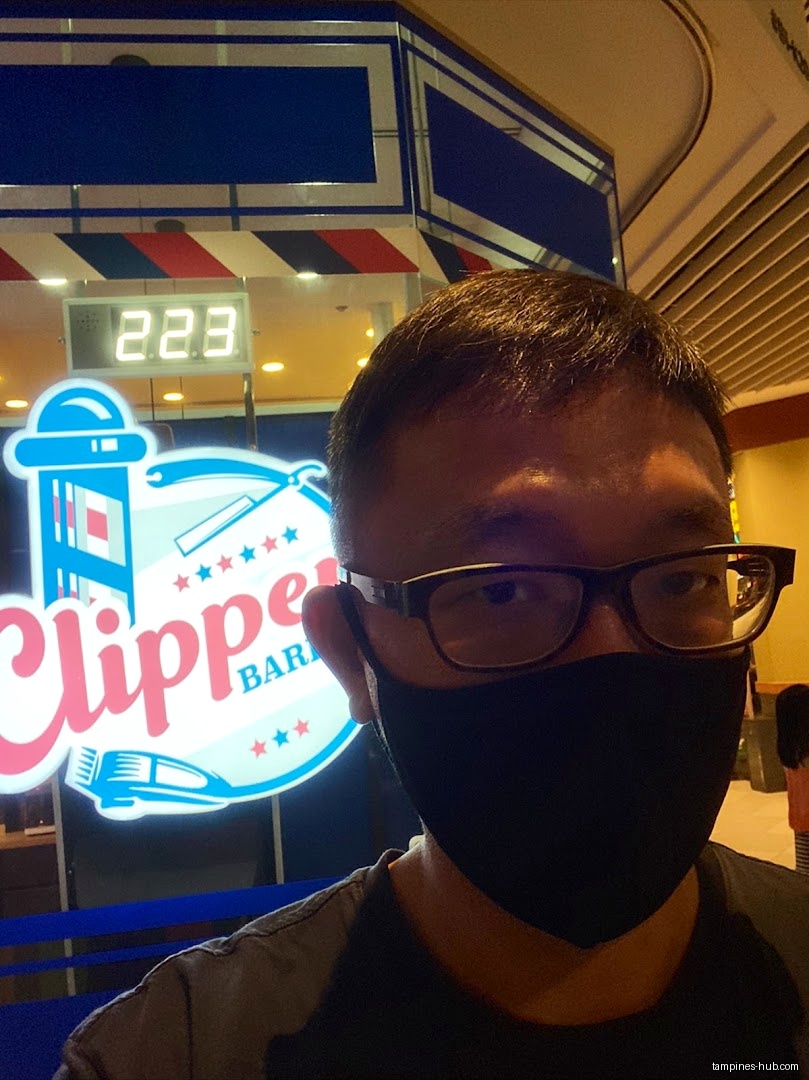 Person in front of Clippers Barber Our Tampines Hub shop front.