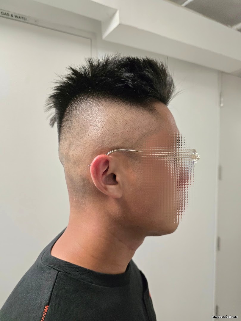 A man with a fresh haircut from Clippers Barber Our Tampines Hub.