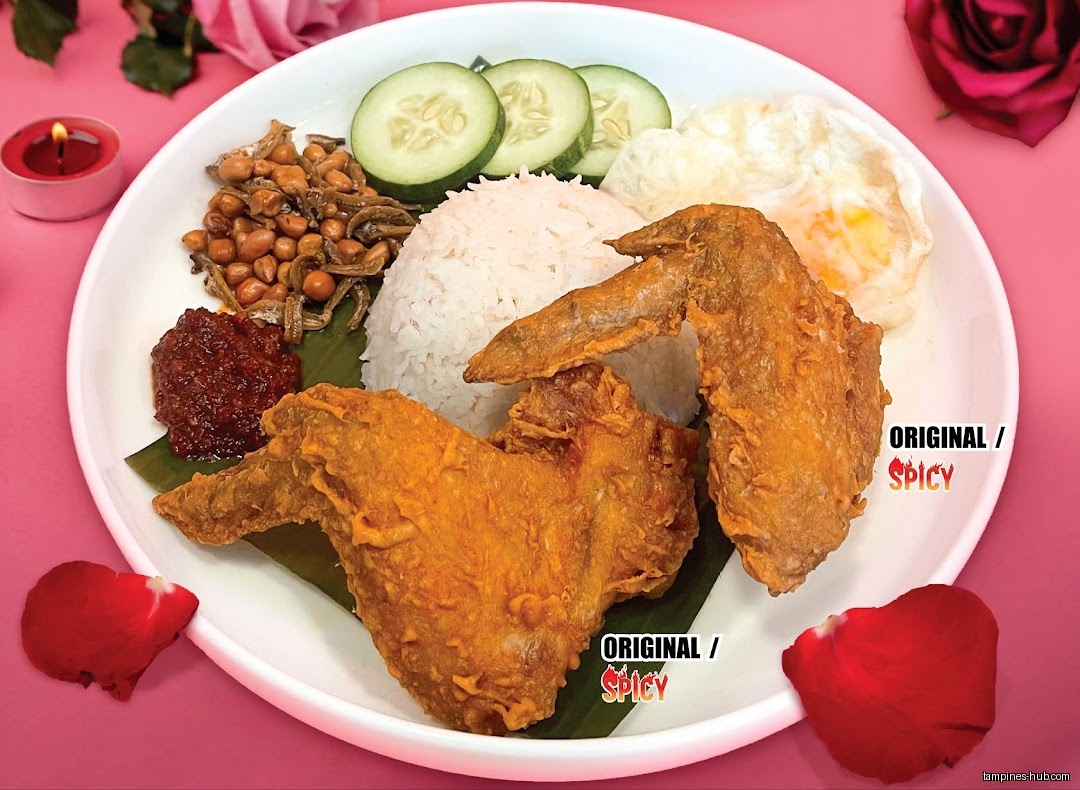 A plate of Nasi Lemak with fried chicken, rice, and condiments.