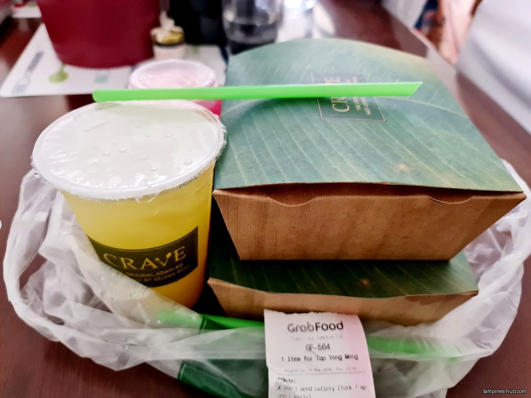 A Crave Nasi Lemak takeaway order with a drink and receipt.