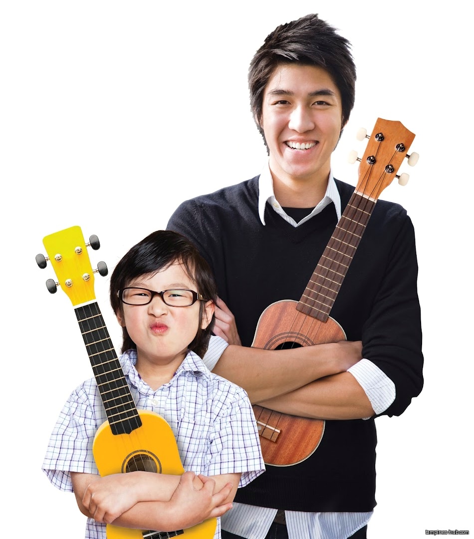 Two people holding ukuleles, one smiling and one making a face.