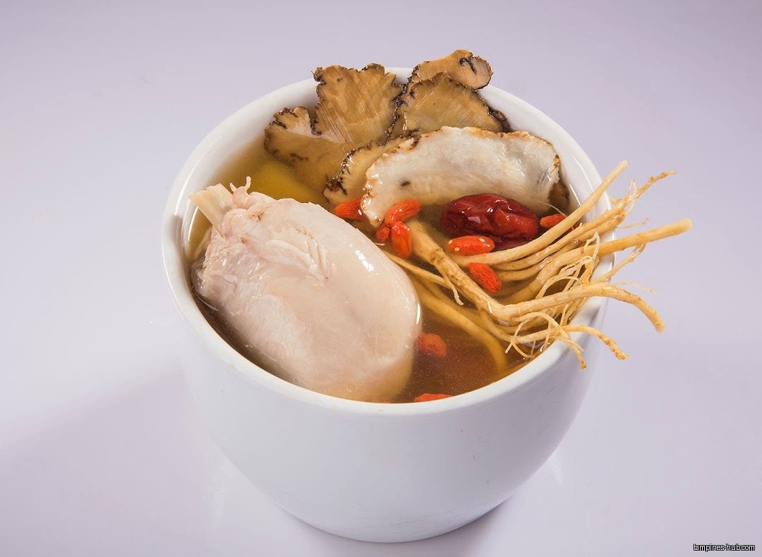 A bowl of Day Night Herbal Soup with chicken and herbs.