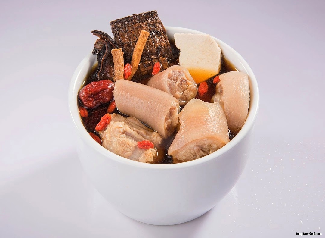 A bowl of Day Night Herbal Soup with meat and herbs.