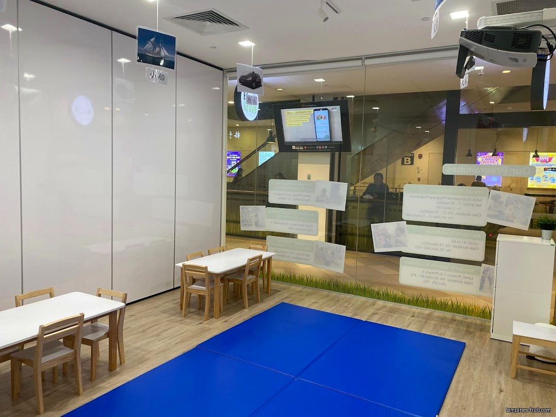EduGrove Tampines classroom with tables, chairs, and a blue mat visible.