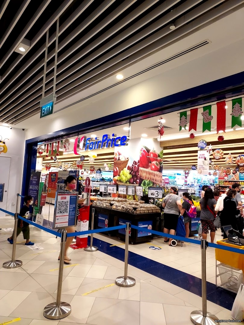 The image shows the entrance of a FairPrice Our Tampines Hub supermarket.