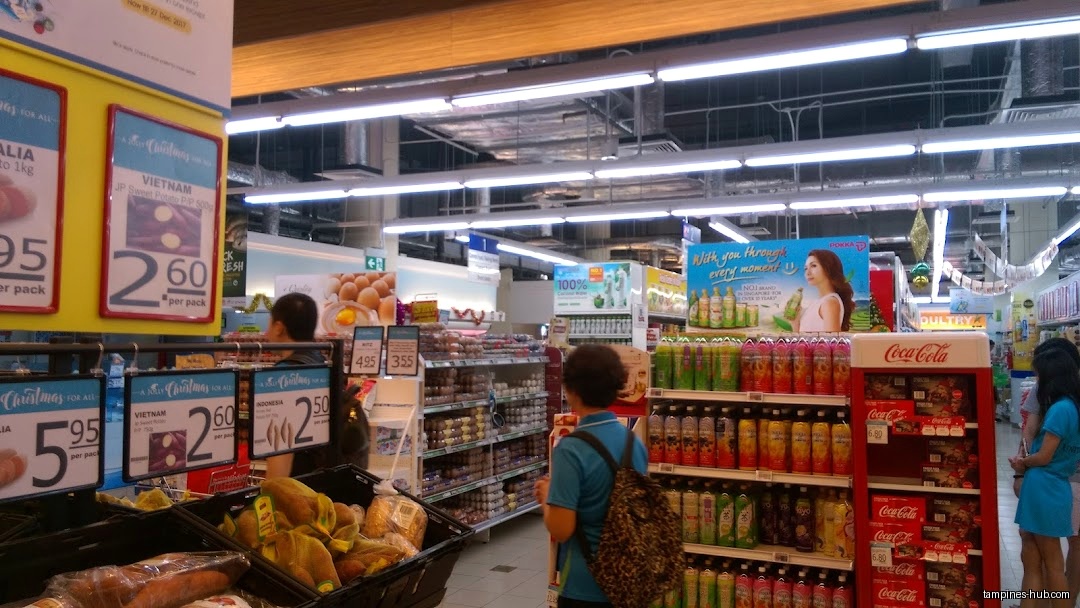 Interior view of FairPrice Our Tampines Hub with produce and drinks.