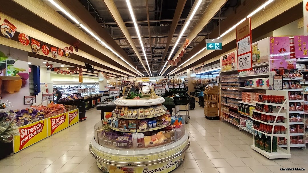 Interior view of FairPrice Our Tampines Hub supermarket with produce and shelves.