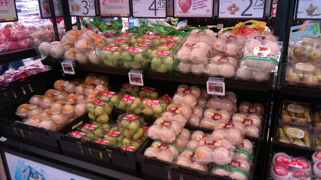 A display of packaged pears and other fruits in a FairPrice store.