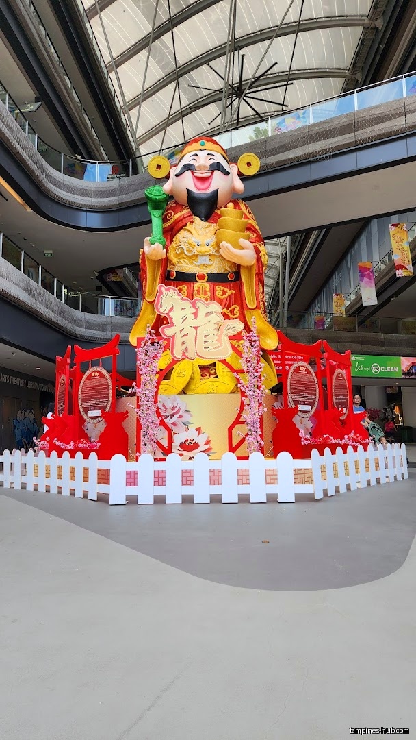 Large statue of a Chinese deity with red and gold decorations.