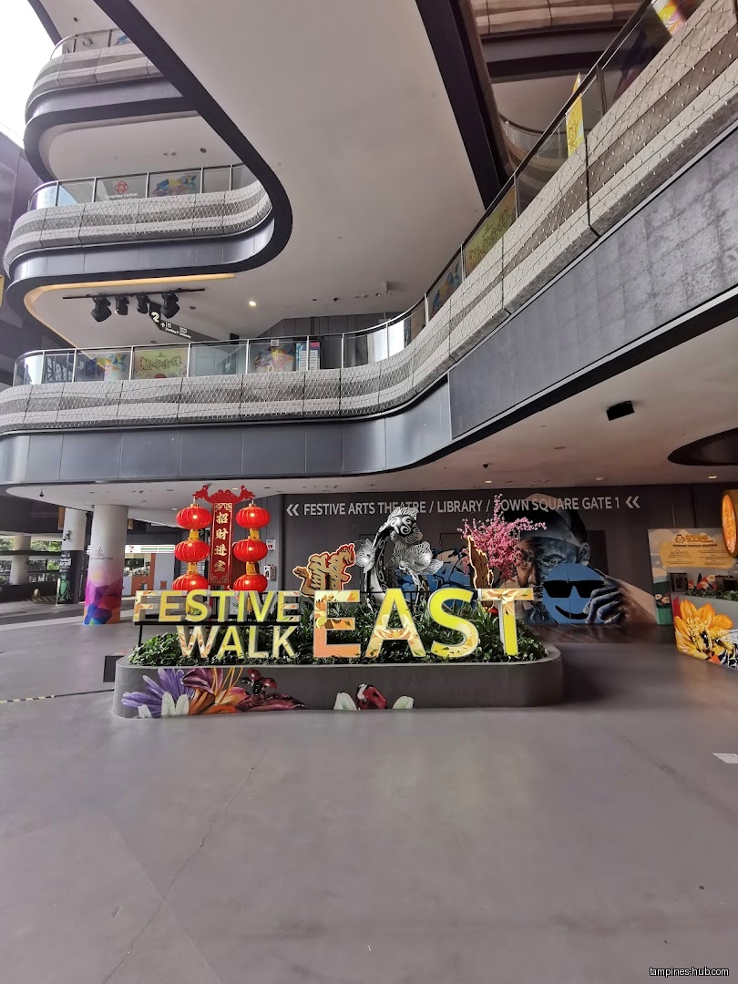 Festive Arts Theatre entrance with 'Festive Walk East' sign and decorations.