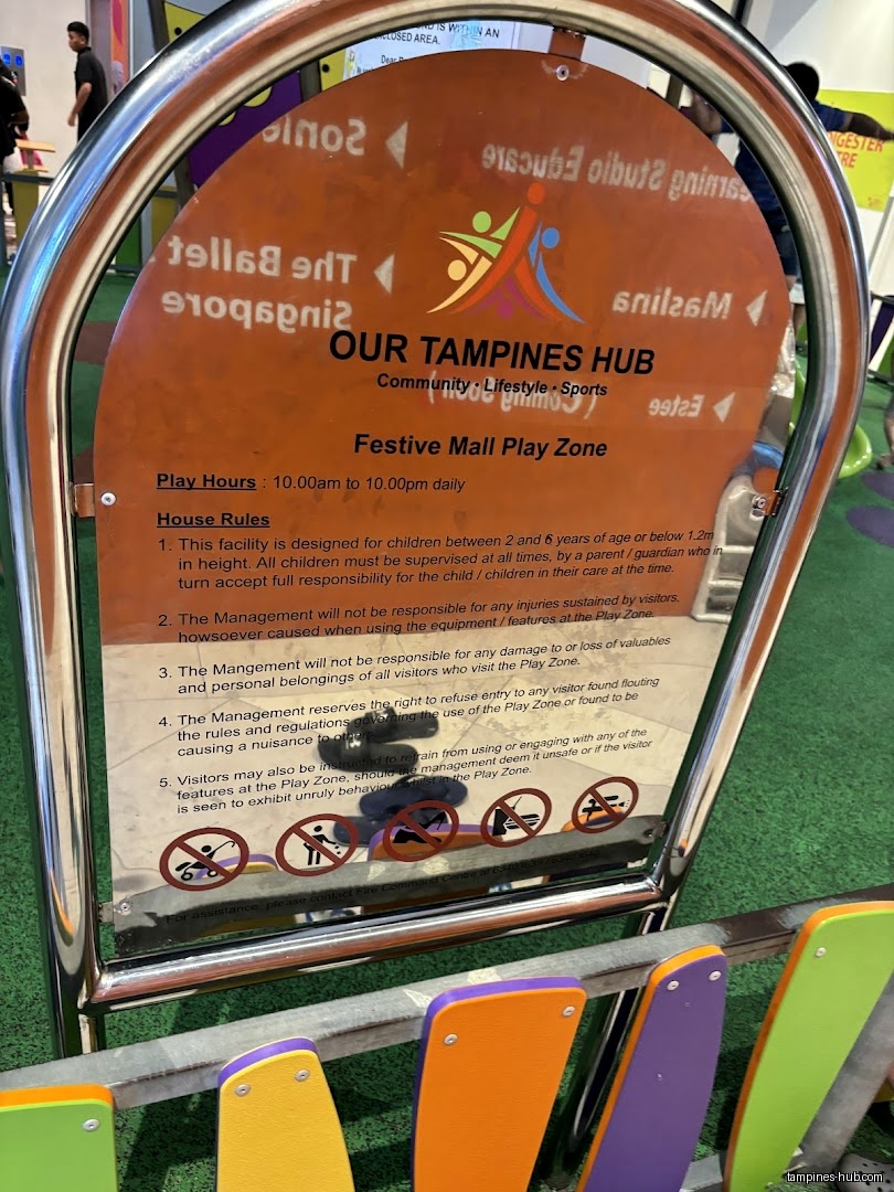 A sign displays the play zone's name, hours, and house rules.