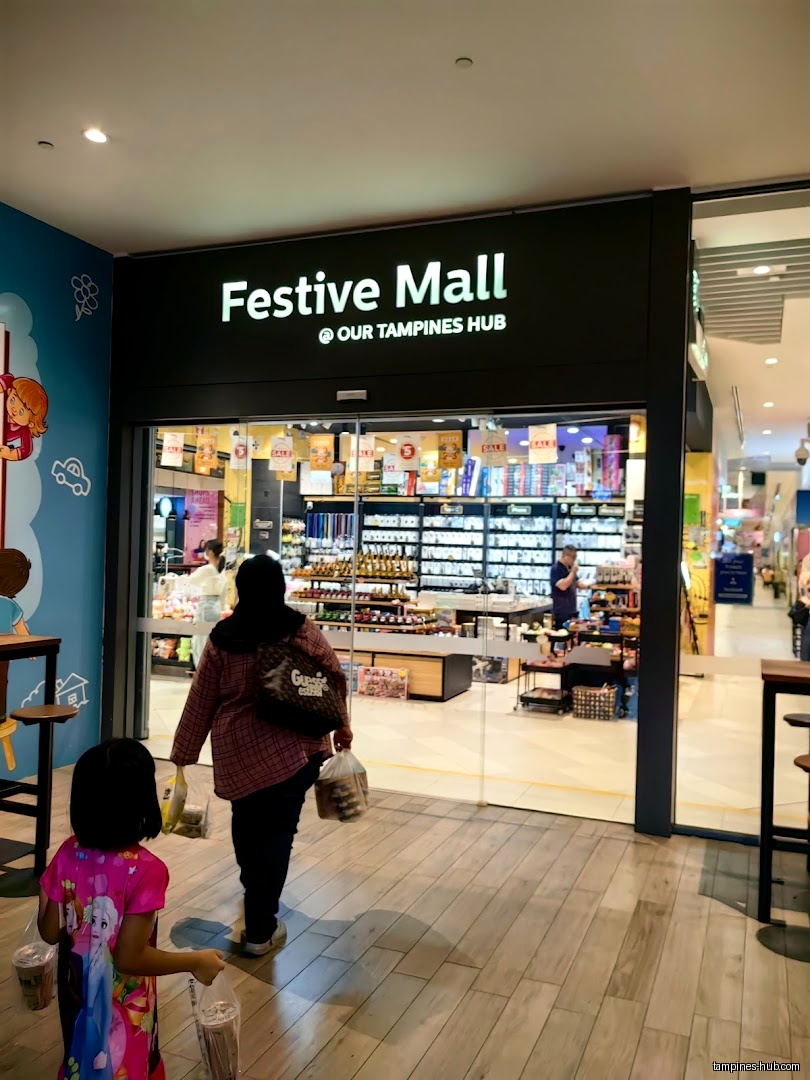 Festive Mall entrance with customers exiting the store.