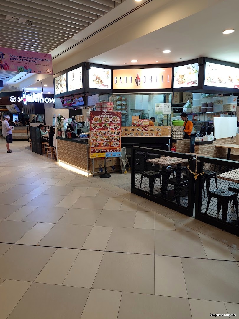 Gado Grill shop front in Festive Mall with menu and seating.